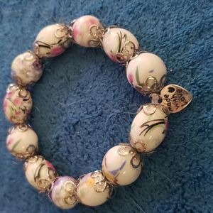 Handcrafted bracelet, shades of rose, pink on a white bead with silver accents.